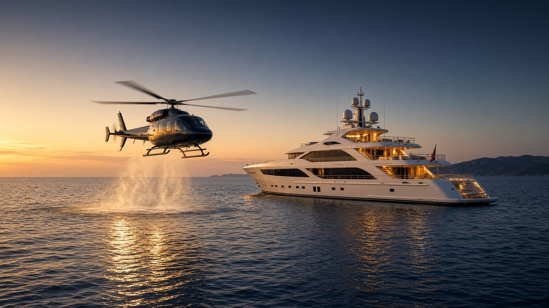 Large VIP helicopter descending toward a gold-lit superyacht at sunset